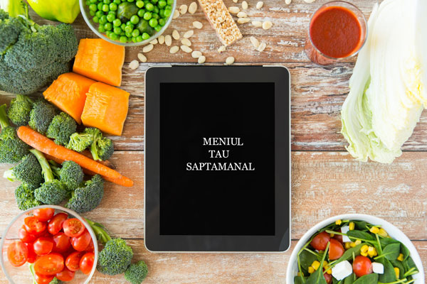 close up of blank tablet pc screen and vegetables